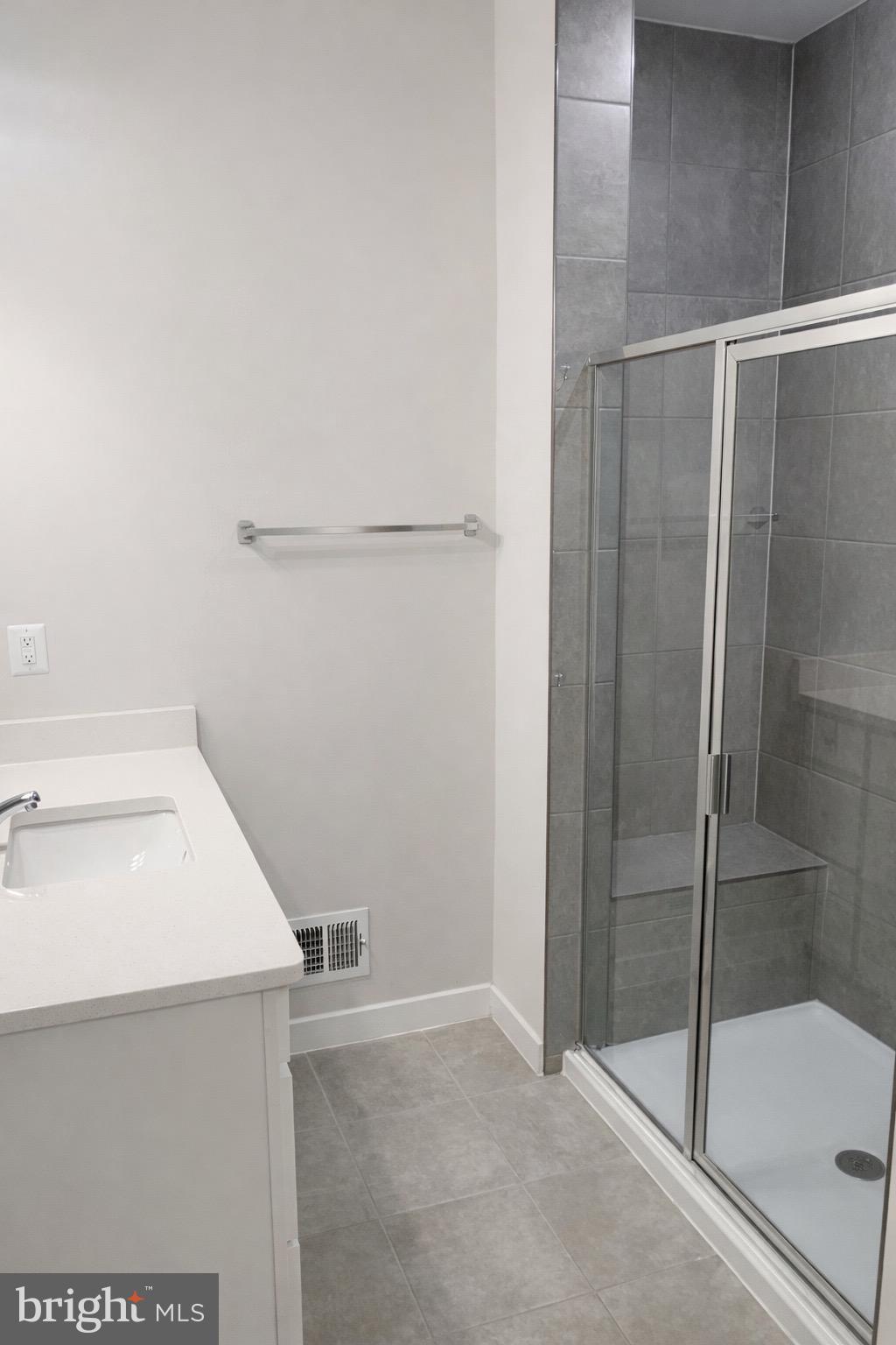 13695 Innovation Station Loop, Unit 77B Herndon, VA 20171 - Photo 7 of 11 a bathroom with a sink and shower