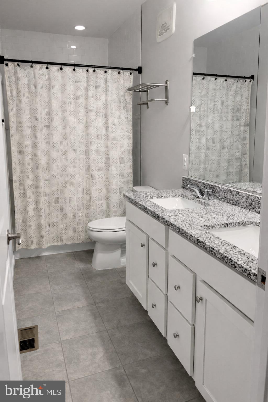 13695 Innovation Station Loop, Unit 77B Herndon, VA 20171 - Photo 9 of 11 a bathroom with a granite countertop sink toilet and shower
