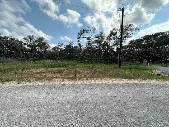 a view of a big house with a big yard and a large trees