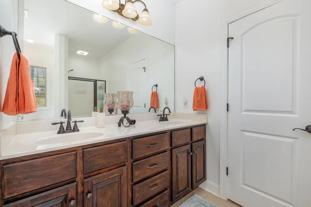 a bathroom with a double vanity sink and a mirror