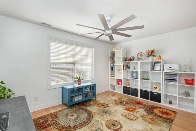 a living room with furniture and a book shelf