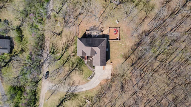 a kitchen with stainless steel appliances kitchen island granite countertop a sink a stove a dining table and chairs with wooden floor