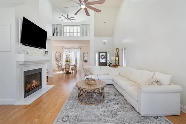 a kitchen with stainless steel appliances granite countertop a sink a stove and white cabinets