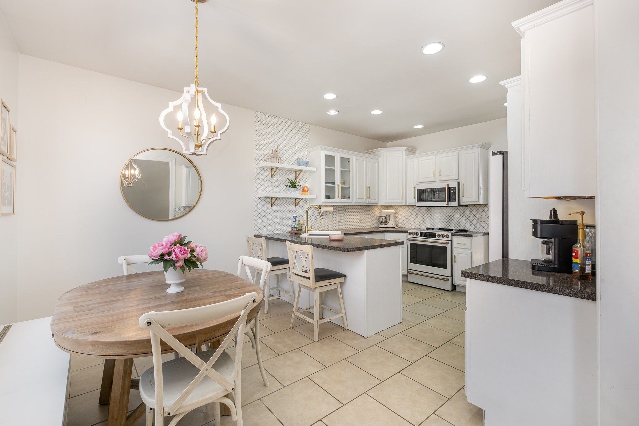 1604 Becca Lane Columbia, TN 38401 - Photo 33 of 54 a kitchen with stainless steel appliances kitchen island granite countertop a sink a stove a dining table and chairs with wooden floor