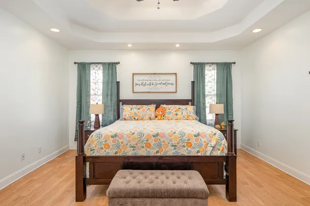 a bedroom with a bed and a chandelier