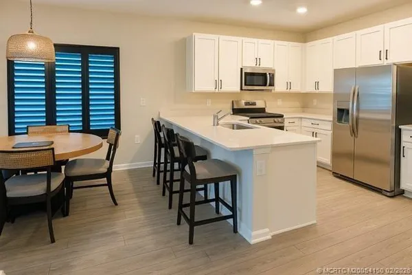 a kitchen with a stove a sink and a refrigerator