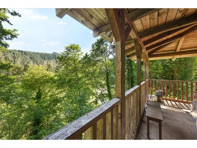 a balcony with wooden floor and outdoor space