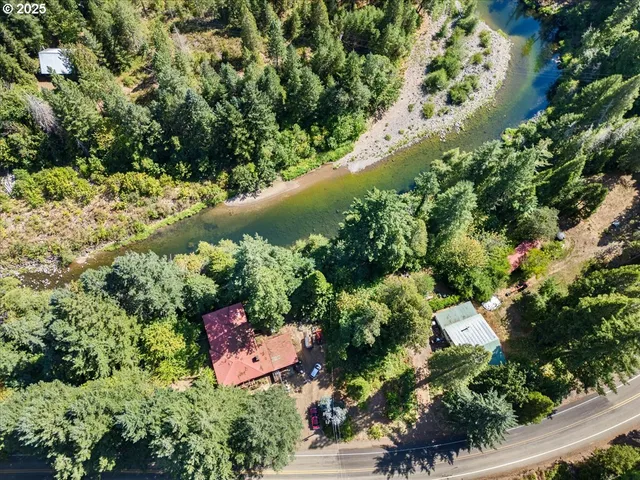 an aerial view of a house with a yard and lake view