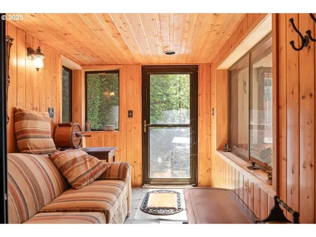 a living room with furniture and a floor to ceiling window
