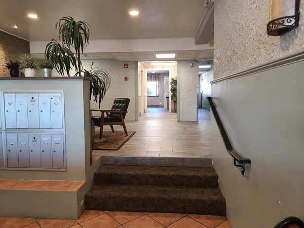 a view of entryway and hall with wooden floor