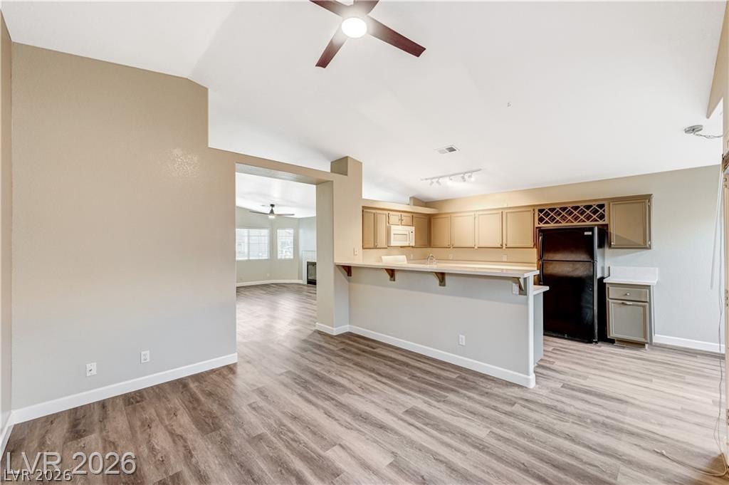 2283 Ramsgate Drive Henderson, NV 89074 - Photo 50 of 51 An open floorplan seamlessly connects the vaulted dining space to a breakfast bar kitchen.