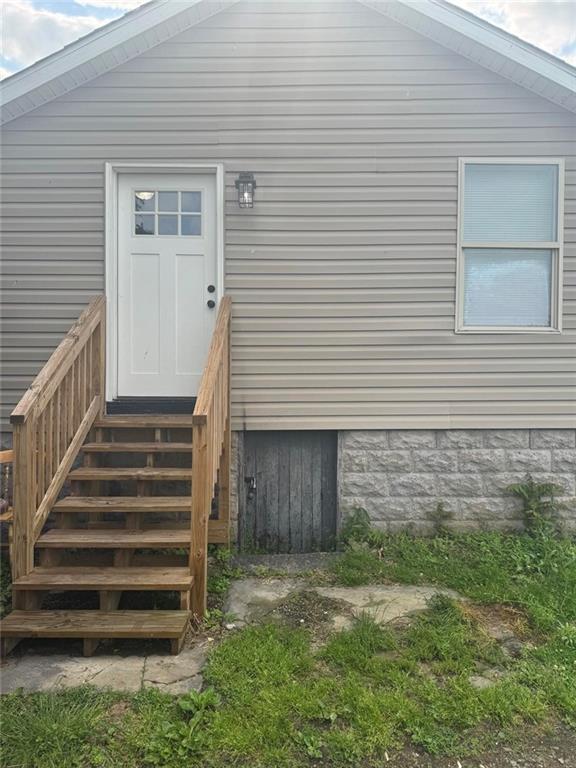 a view of a house with a yard and stairs