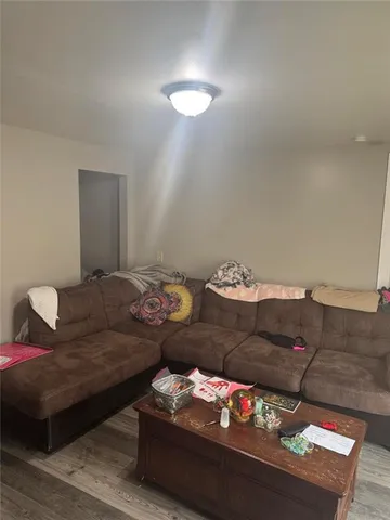 a living room with furniture and white walls
