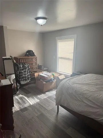 a bedroom with a bed and window