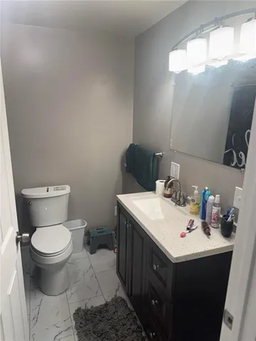 a bathroom with a sink toilet and mirror