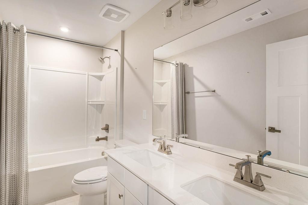 4003 Bluebell Lane Spring Hill, TN 37174 - Photo 35 of 40 a bathroom with a bathtub shower sink vanity mirror and toilet