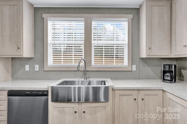 a kitchen with granite countertop a sink and a window