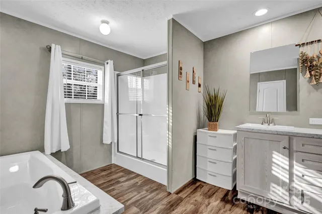 a bathroom with a sink a mirror and a shower