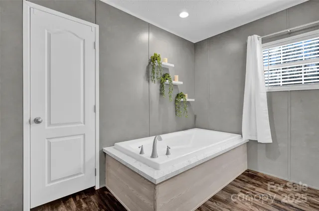 a bathroom with a tub and shower