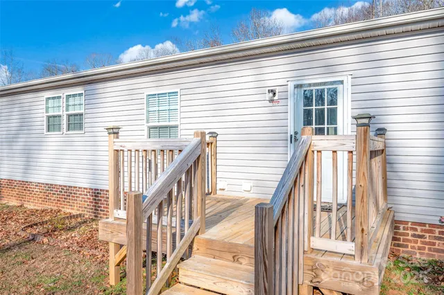 a view of balcony with wooden floor and fence