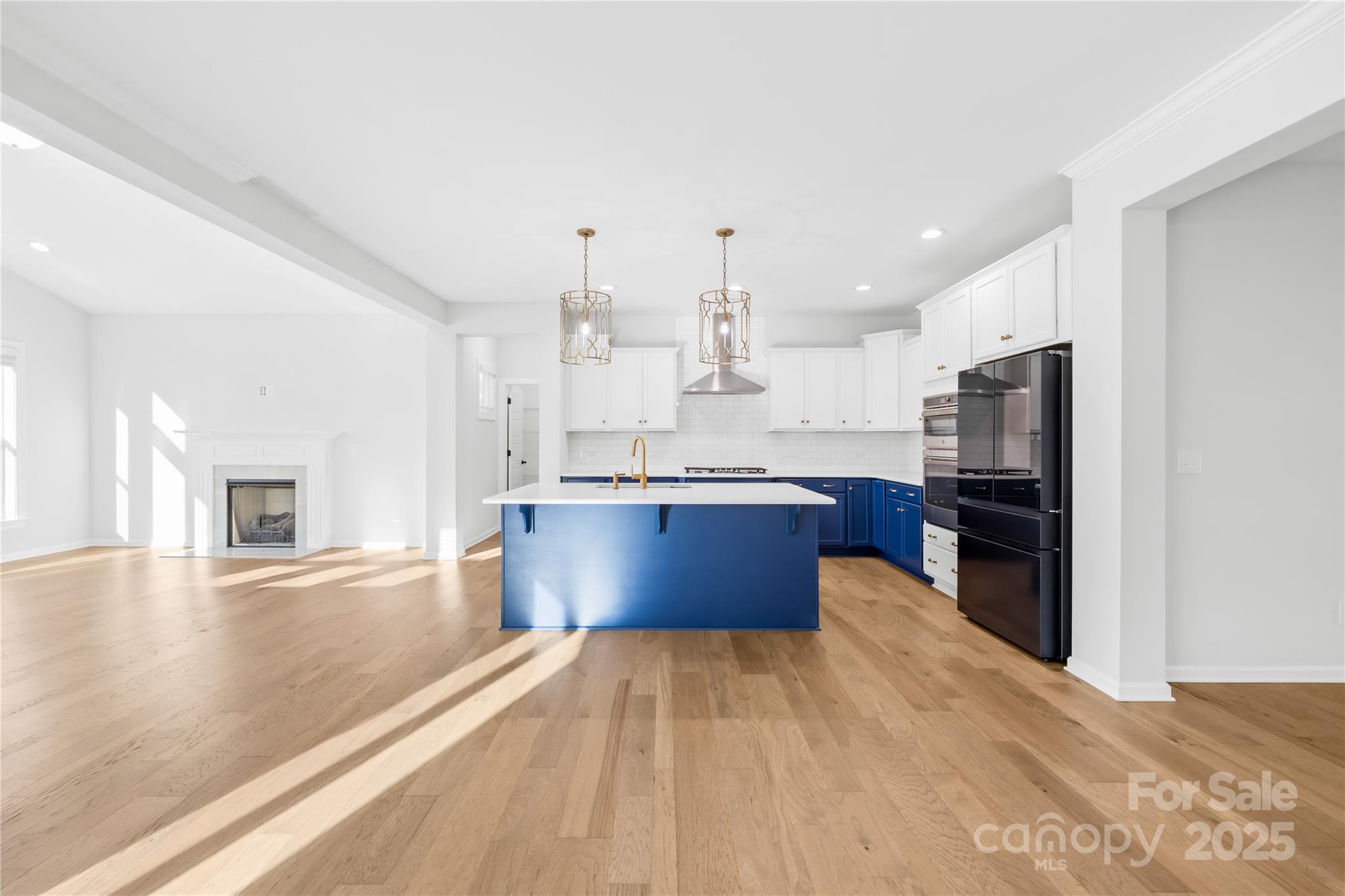 8005 Rolling Wheels Road Charlotte, NC 28215 - Photo 12 of 40 a large kitchen with stainless steel appliances kitchen island granite countertop a large counter top and oven