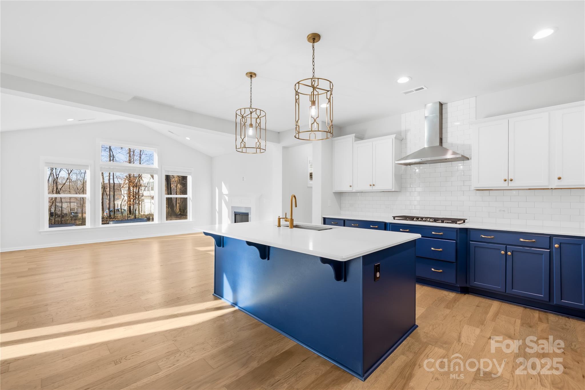8005 Rolling Wheels Road Charlotte, NC 28215 - Photo 14 of 40 a kitchen with stainless steel appliances granite countertop a sink dishwasher stove and wooden floor