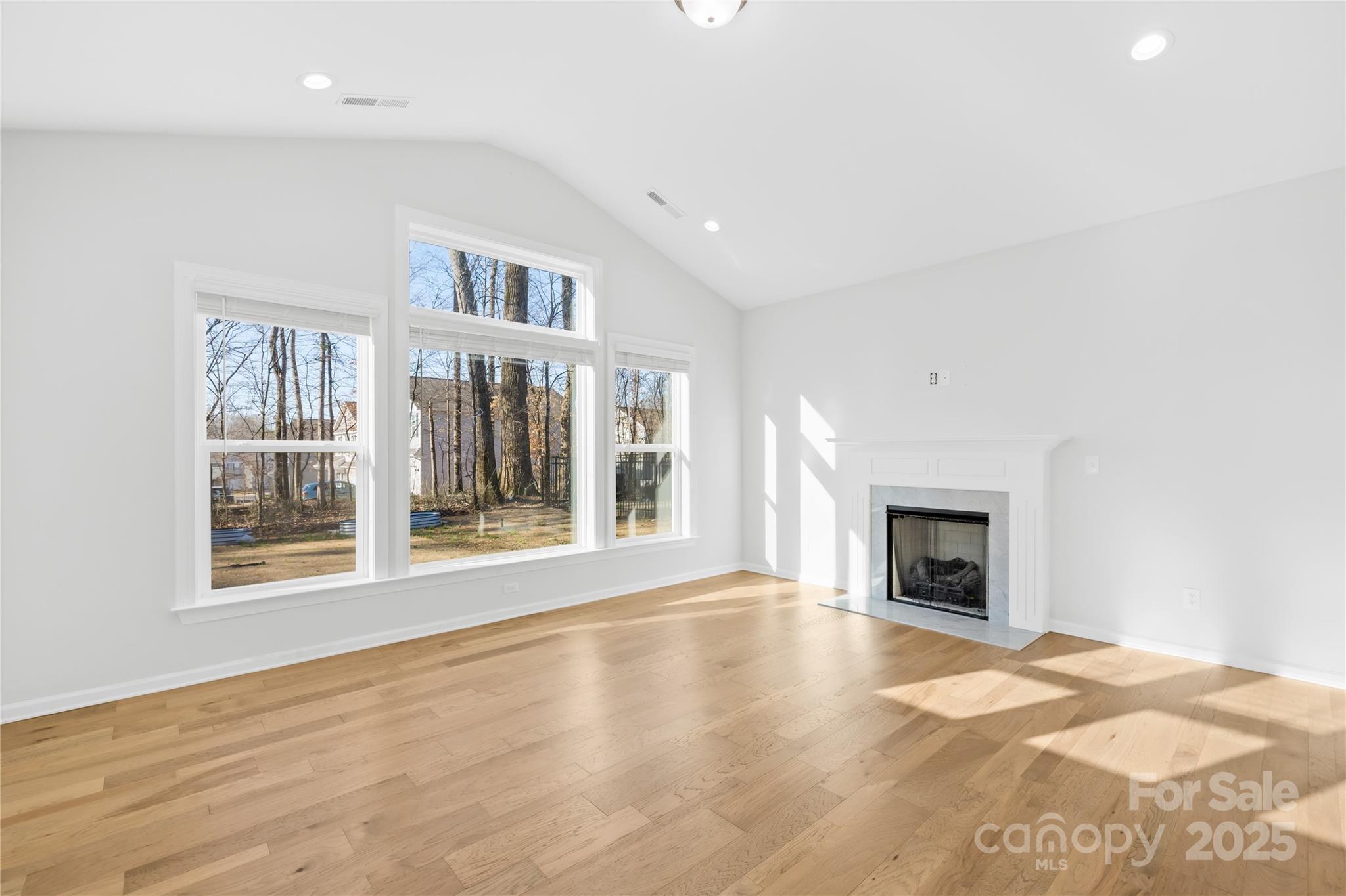 8005 Rolling Wheels Road Charlotte, NC 28215 - Photo 18 of 40 a view of an empty room with wooden floor and a window