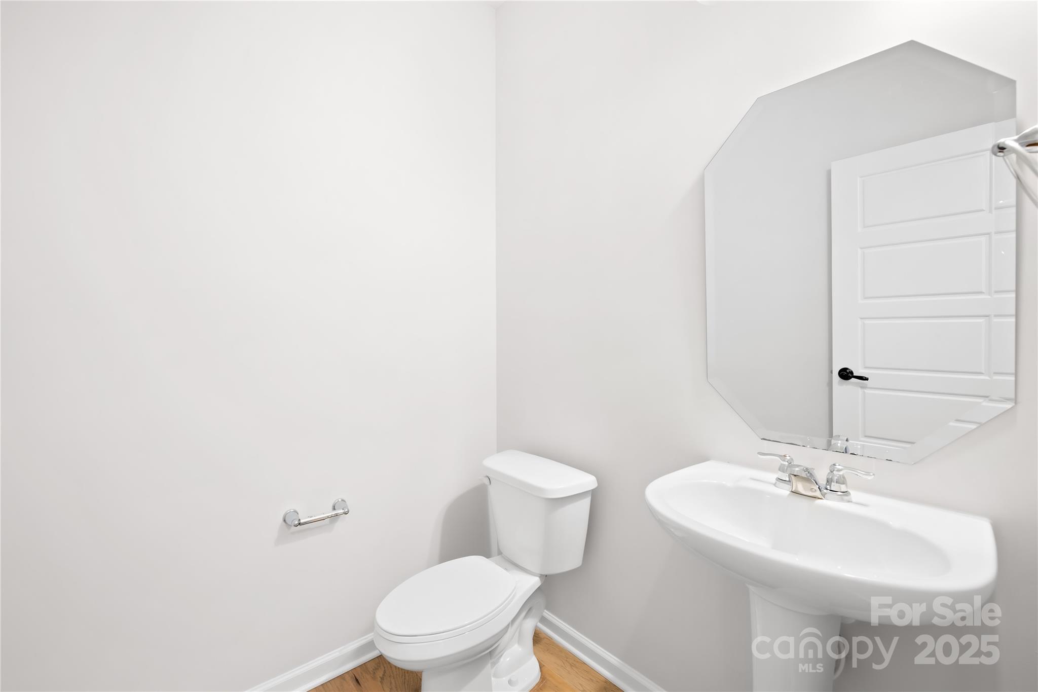 8005 Rolling Wheels Road Charlotte, NC 28215 - Photo 21 of 40 a bathroom with a sink a toilet and mirror