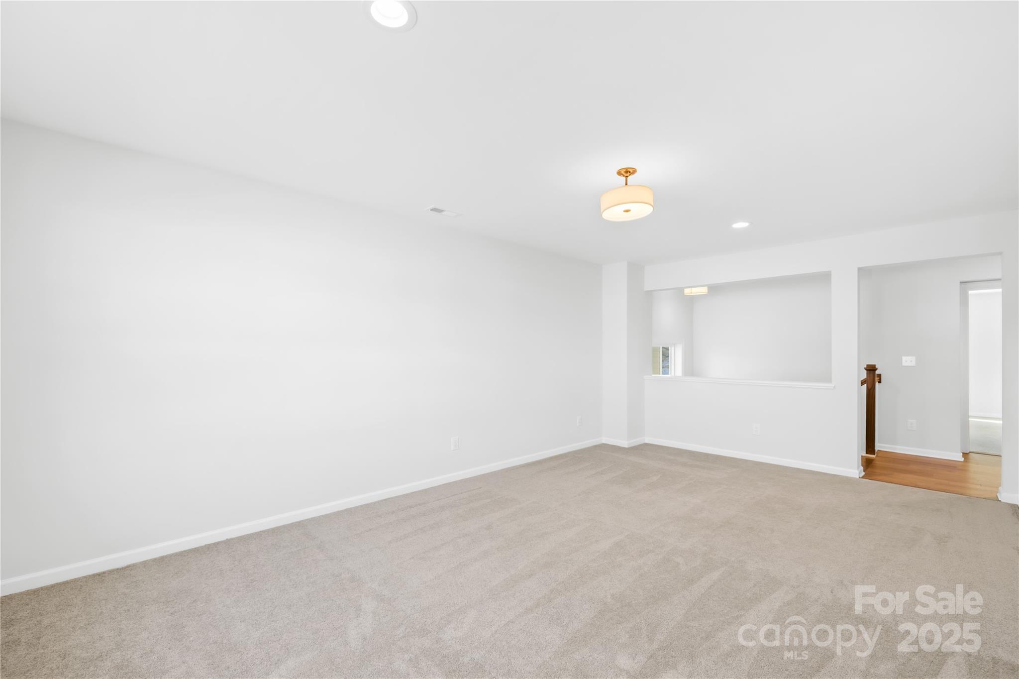 8005 Rolling Wheels Road Charlotte, NC 28215 - Photo 24 of 40 wooden floor in an empty room with a ceiling fan