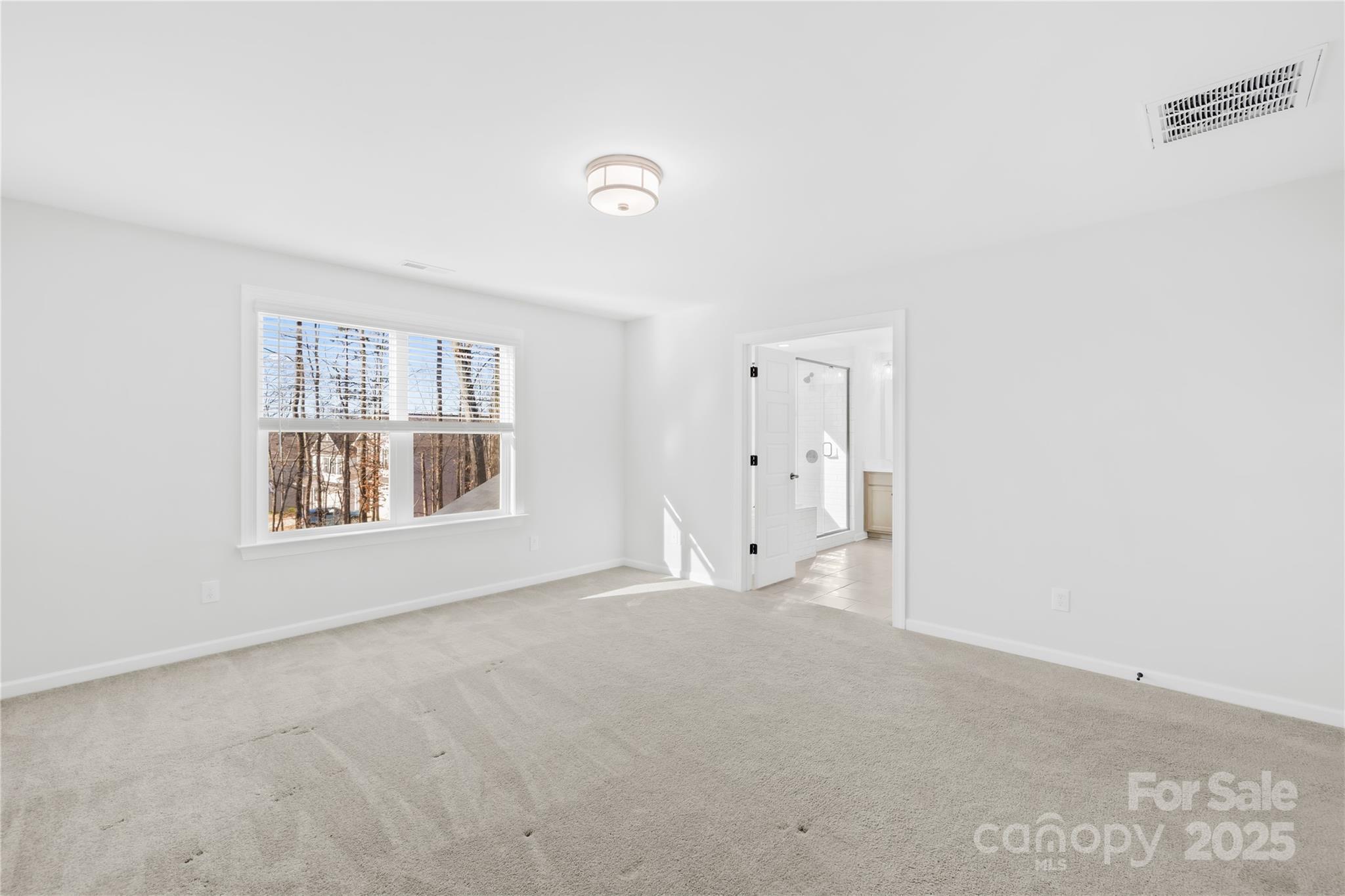 8005 Rolling Wheels Road Charlotte, NC 28215 - Photo 26 of 40 a view of an empty room with a window and a bathroom