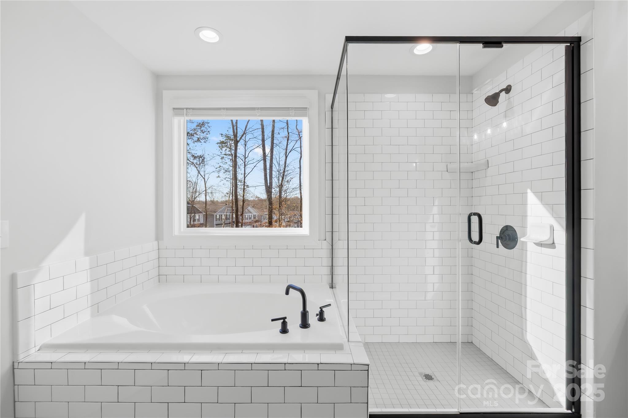 8005 Rolling Wheels Road Charlotte, NC 28215 - Photo 28 of 40 a bathroom with a bathtub and shower