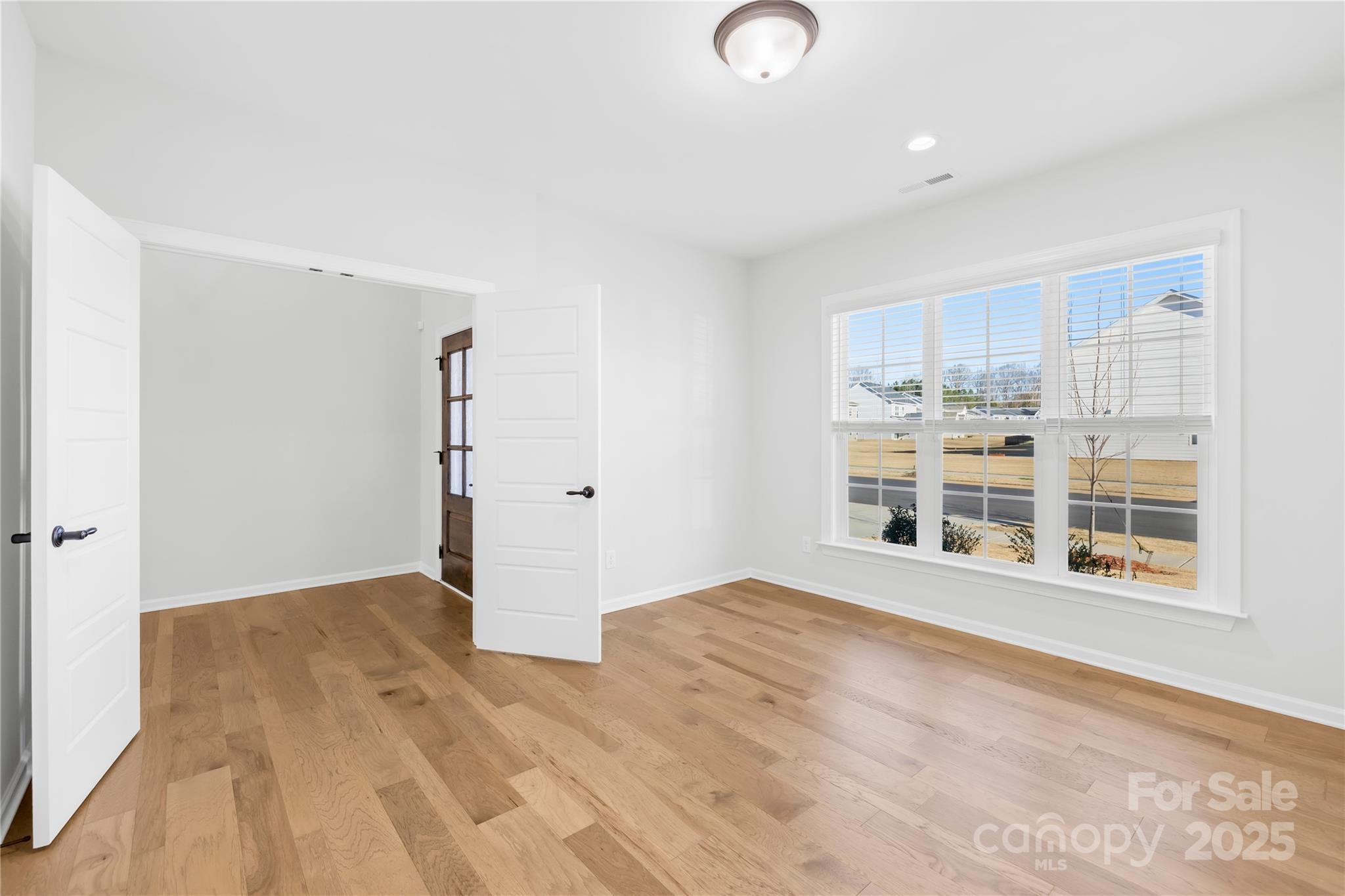 8005 Rolling Wheels Road Charlotte, NC 28215 - Photo 6 of 40 a view of an empty room with a window