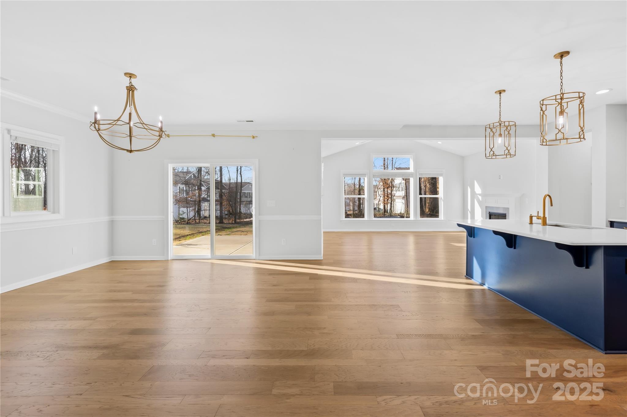 8005 Rolling Wheels Road Charlotte, NC 28215 - Photo 7 of 40 a view of a livingroom with wooden floor and kitchen space