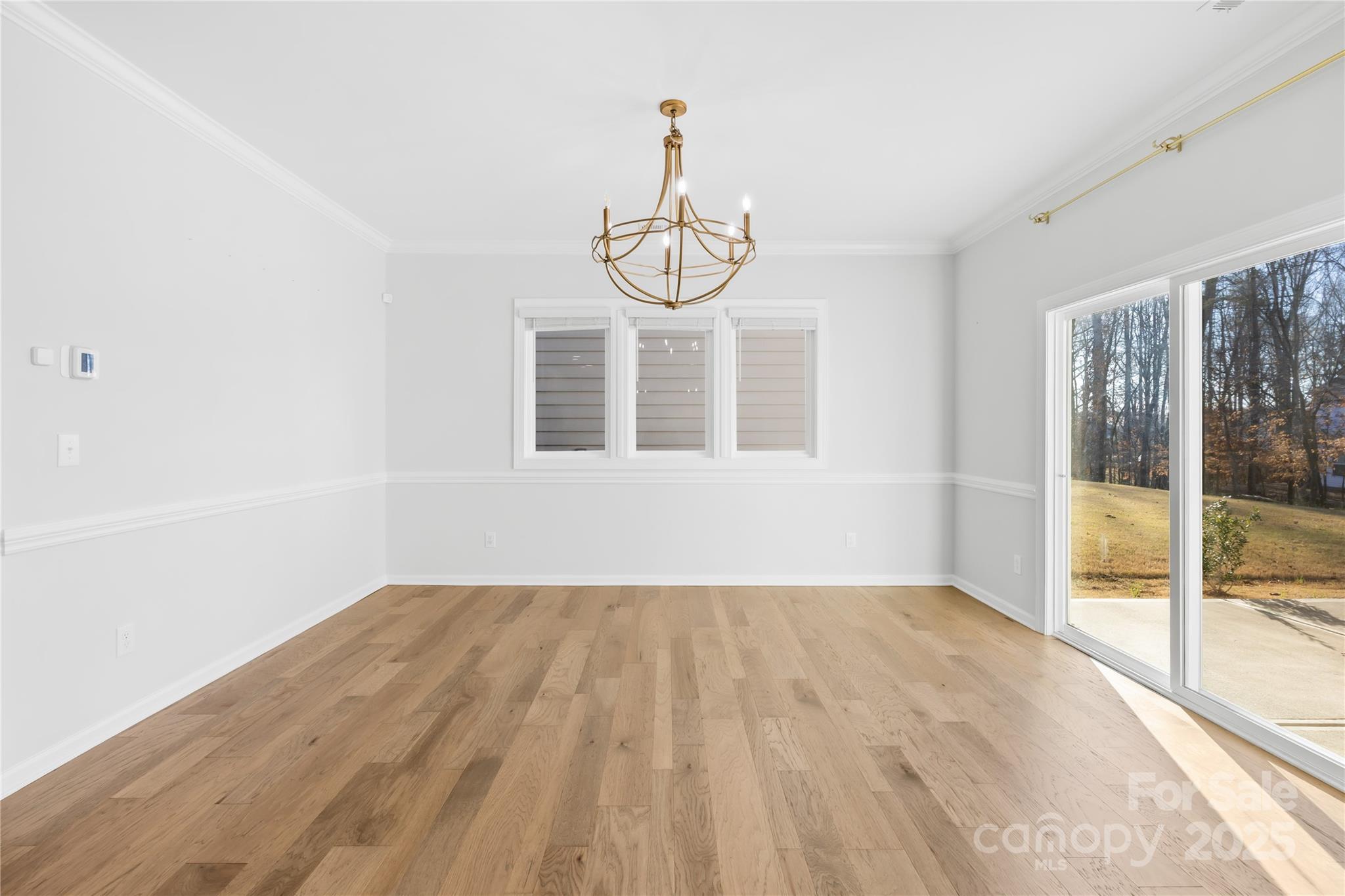 8005 Rolling Wheels Road Charlotte, NC 28215 - Photo 9 of 40 a view of empty room with wooden floor and fan
