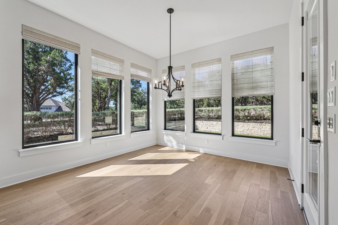 19316 Splendor Court Jonestown, TX 78645 - Photo 11 of 40 a view of an empty room with wooden floor and a window