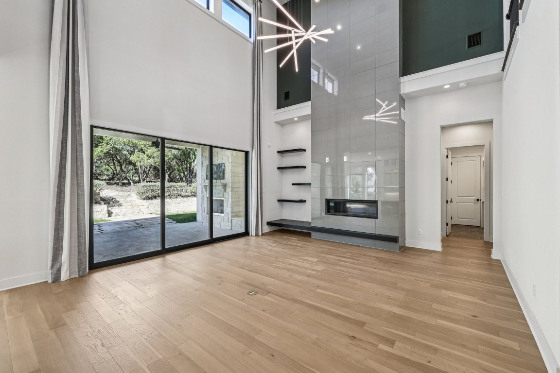 19316 Splendor Court Jonestown, TX 78645 - Photo 14 of 40 a view of a room with wooden floor and windows