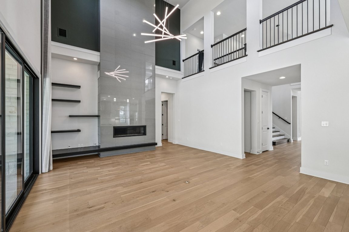 19316 Splendor Court Jonestown, TX 78645 - Photo 15 of 40 wooden floor in an empty room with a bathroom