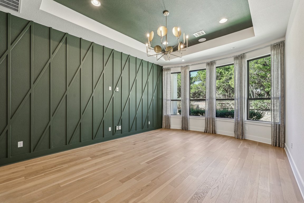 19316 Splendor Court Jonestown, TX 78645 - Photo 16 of 40 a view of an empty room with wooden floor and a window