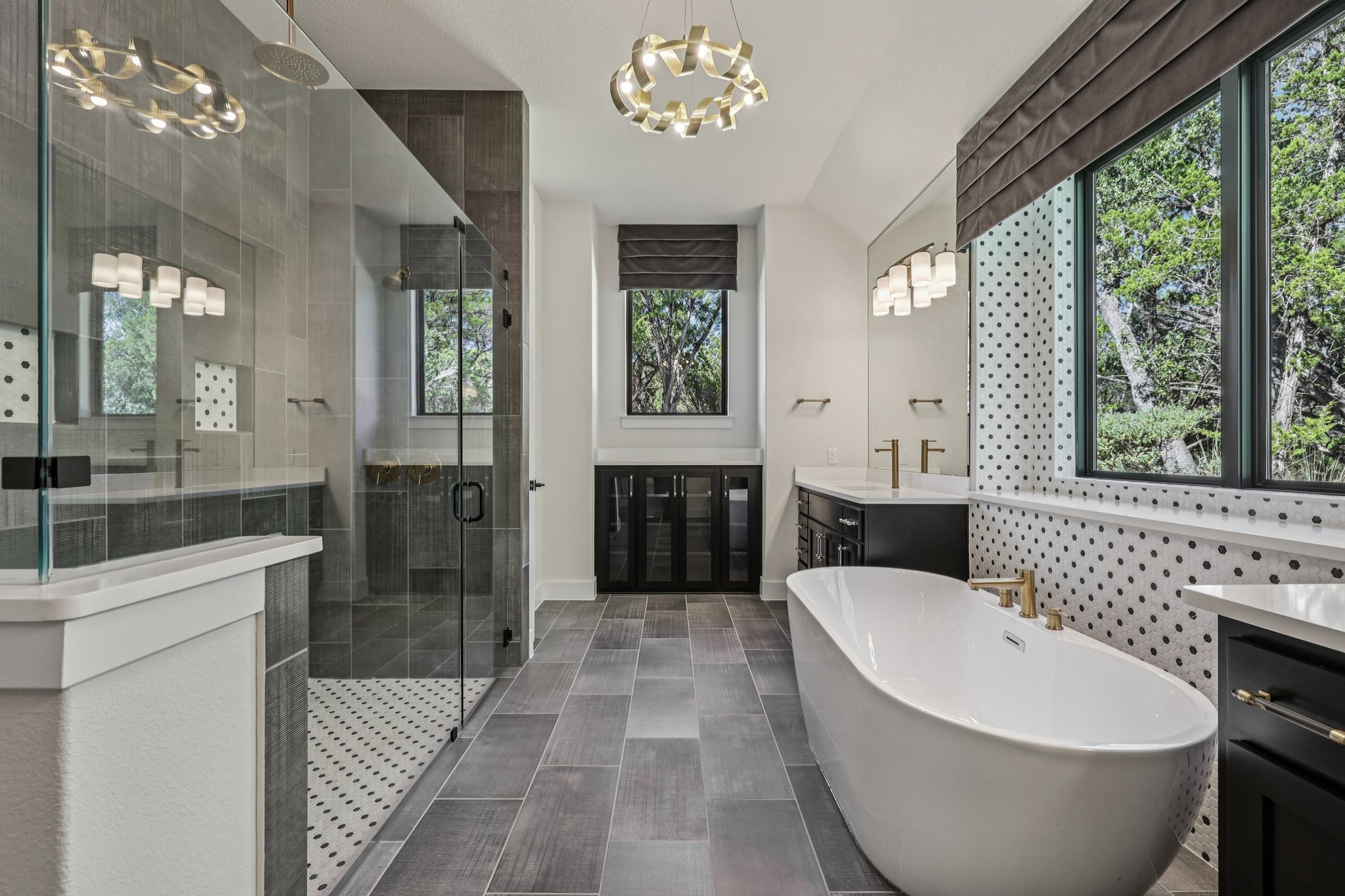 19316 Splendor Court Jonestown, TX 78645 - Photo 19 of 40 a spacious bathroom with a bathtub a sink and a large mirror