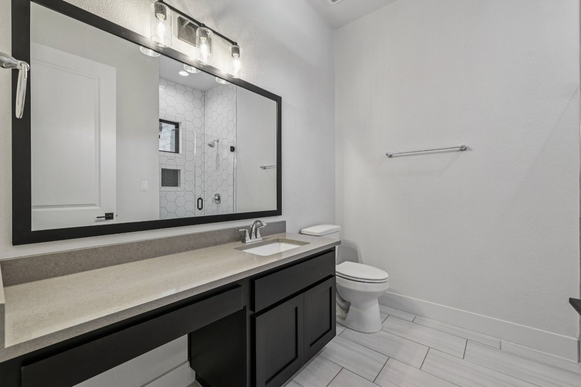 19316 Splendor Court Jonestown, TX 78645 - Photo 26 of 40 a bathroom with a double vanity sink and a mirror