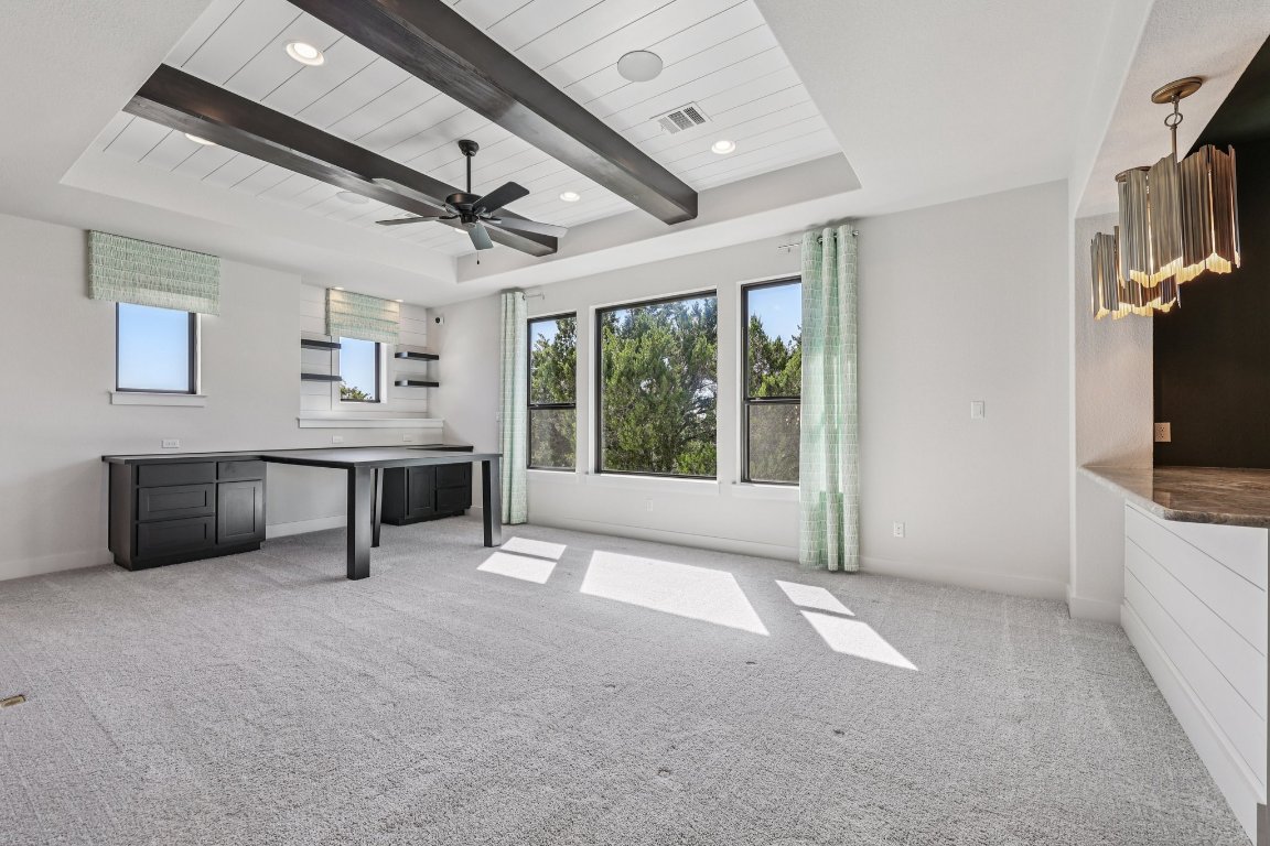 19316 Splendor Court Jonestown, TX 78645 - Photo 28 of 40 a living room with furniture a flat screen tv and a fireplace