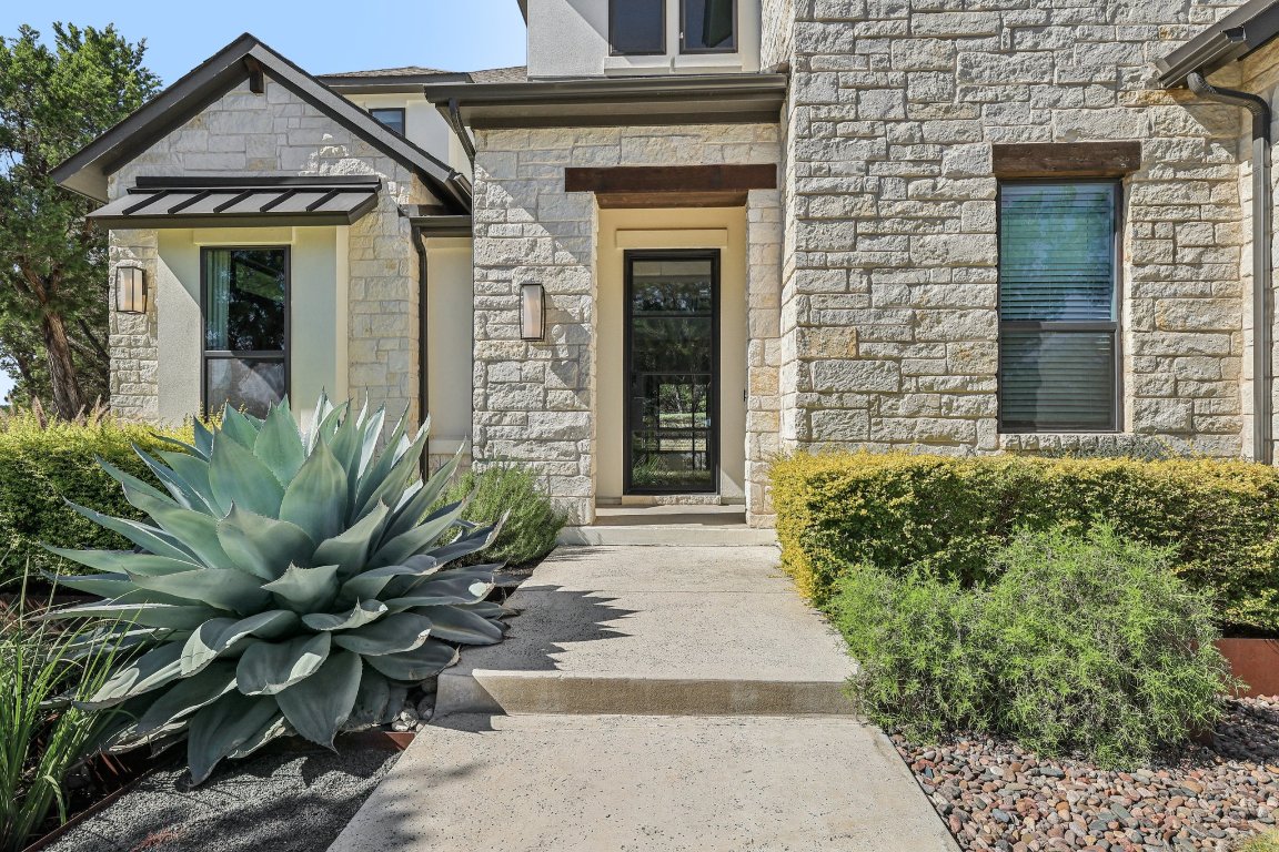 19316 Splendor Court Jonestown, TX 78645 - Photo 3 of 40 a front view of a house with a garden