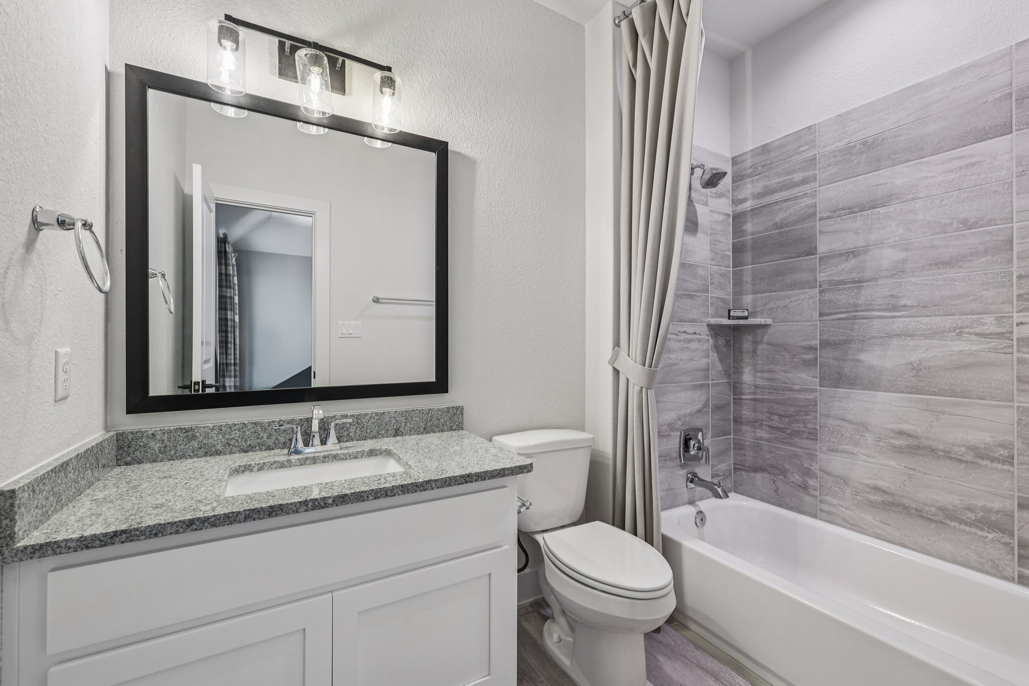 19316 Splendor Court Jonestown, TX 78645 - Photo 33 of 40 a bathroom with a granite countertop sink toilet and shower