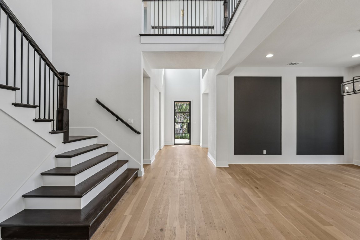 19316 Splendor Court Jonestown, TX 78645 - Photo 4 of 40 a view of a hallway with wooden floor and staircase