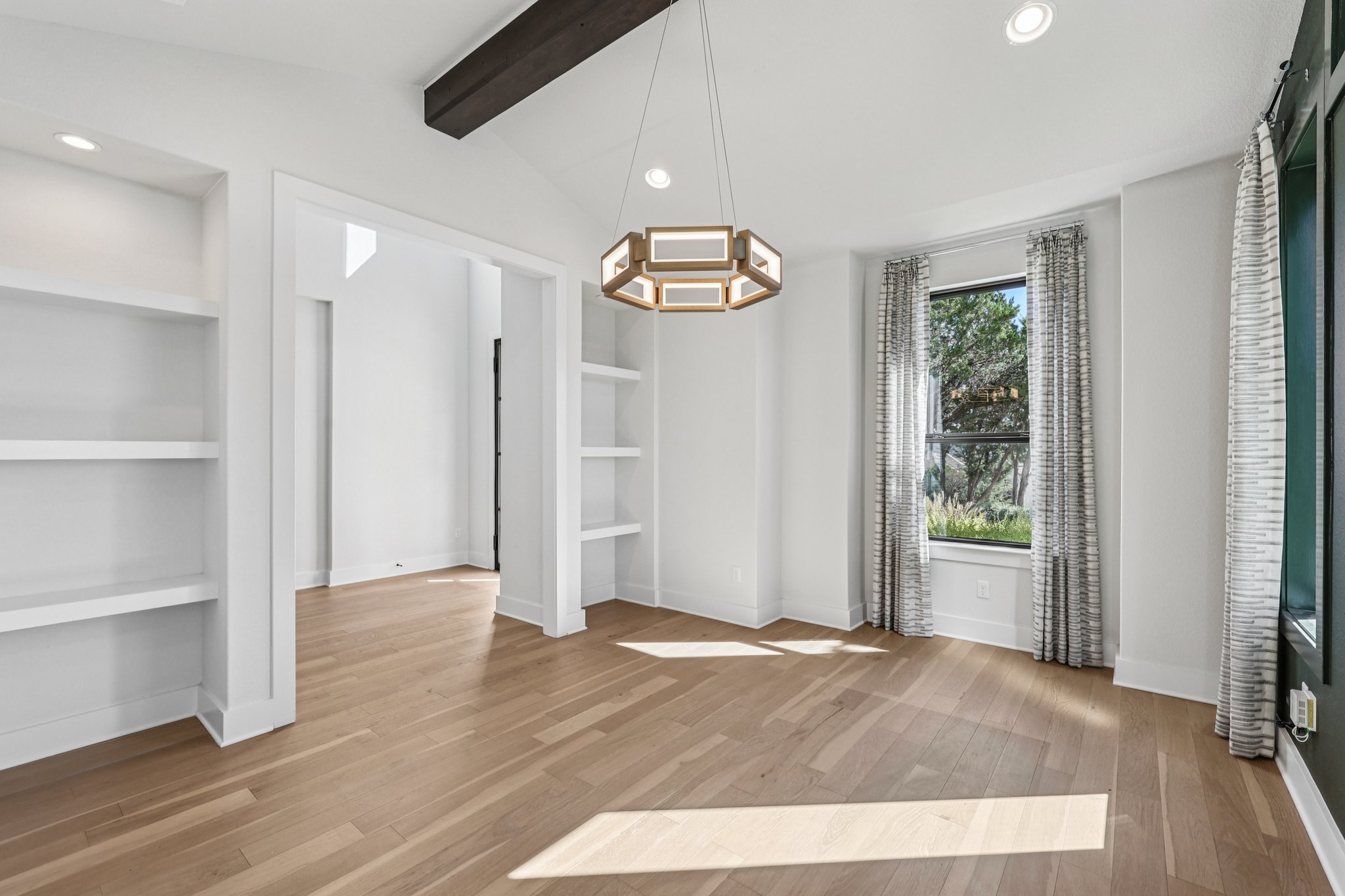 19316 Splendor Court Jonestown, TX 78645 - Photo 6 of 40 a view of an empty room with wooden floor and window