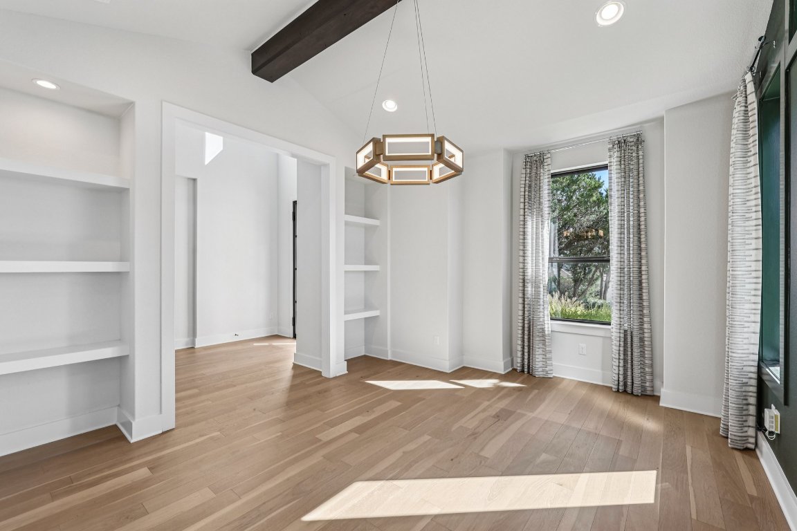 19316 Splendor Court Jonestown, TX 78645 - Photo 6 of 40 a view of an empty room with wooden floor and window