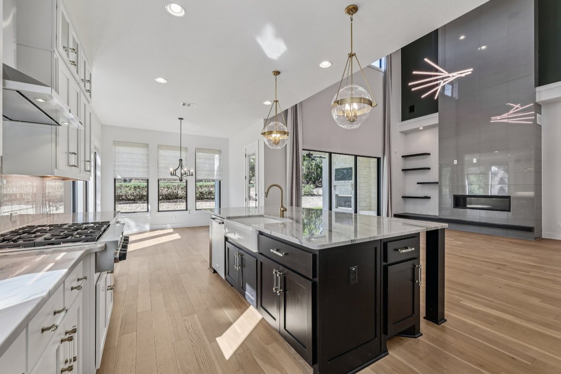 19316 Splendor Court Jonestown, TX 78645 - Photo 9 of 40 a kitchen with stainless steel appliances granite countertop a stove and a view of kitchen