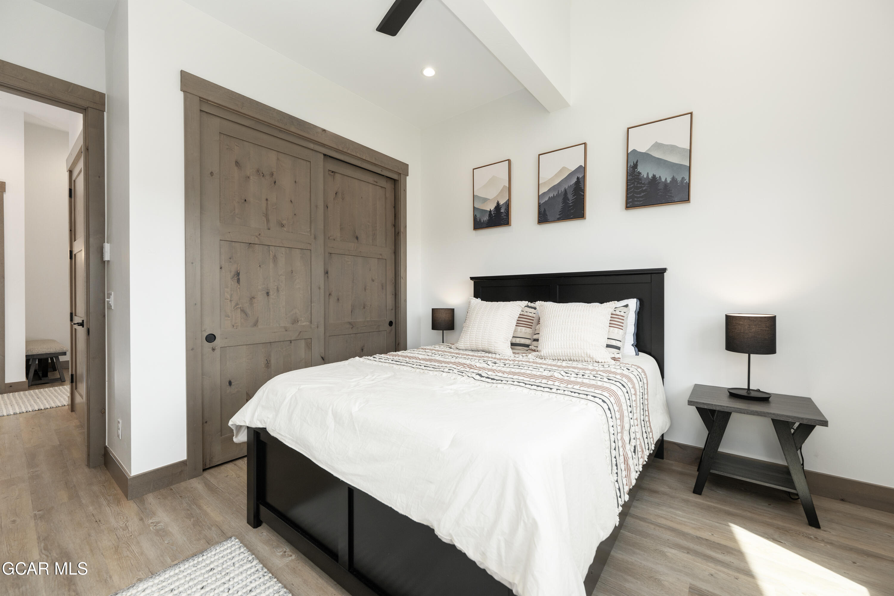 96 Meadow Trail, Unit G304 Fraser, CO 80442 - Photo 27 of 37 a bedroom with a bed and a night stand