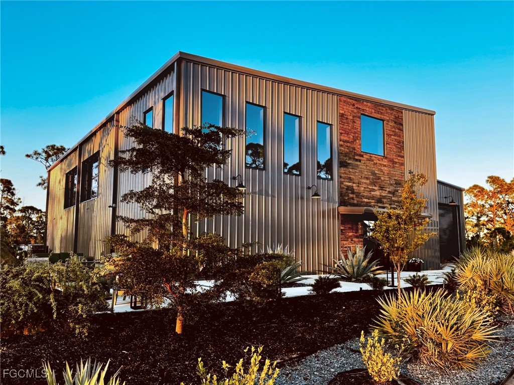 4412 Pinetree Boulevard St. James City, FL 33956 - Photo 2 of 50 a front view of a house with a yard