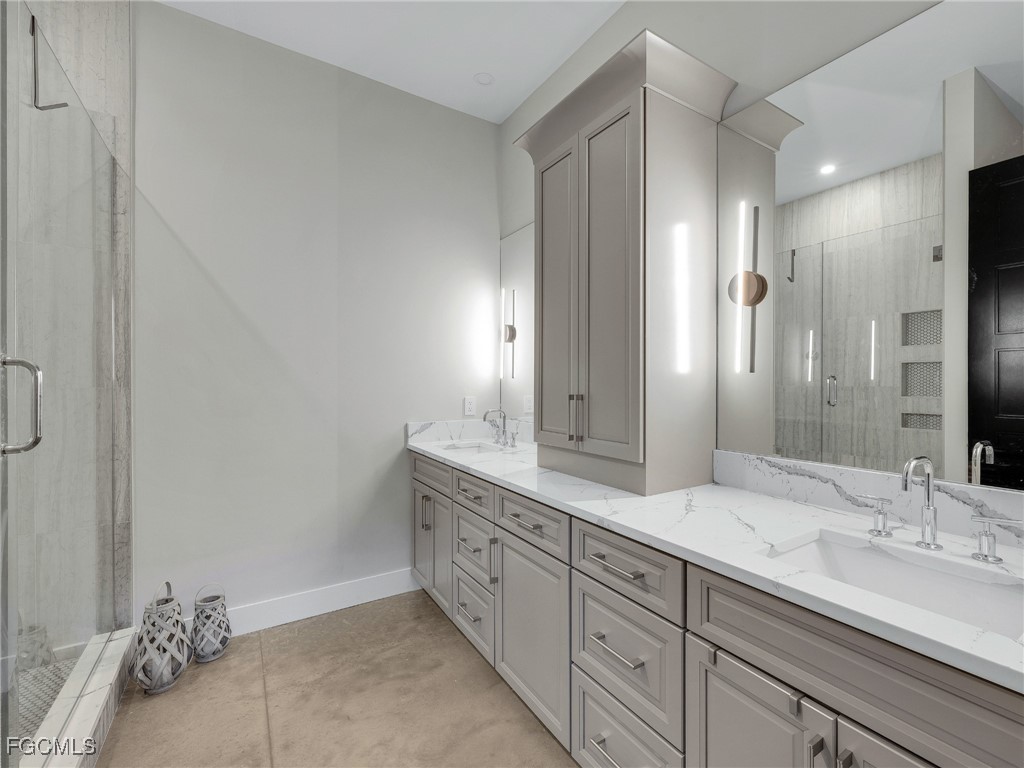 4412 Pinetree Boulevard St. James City, FL 33956 - Photo 35 of 50 a bathroom with a double vanity sink and a mirror